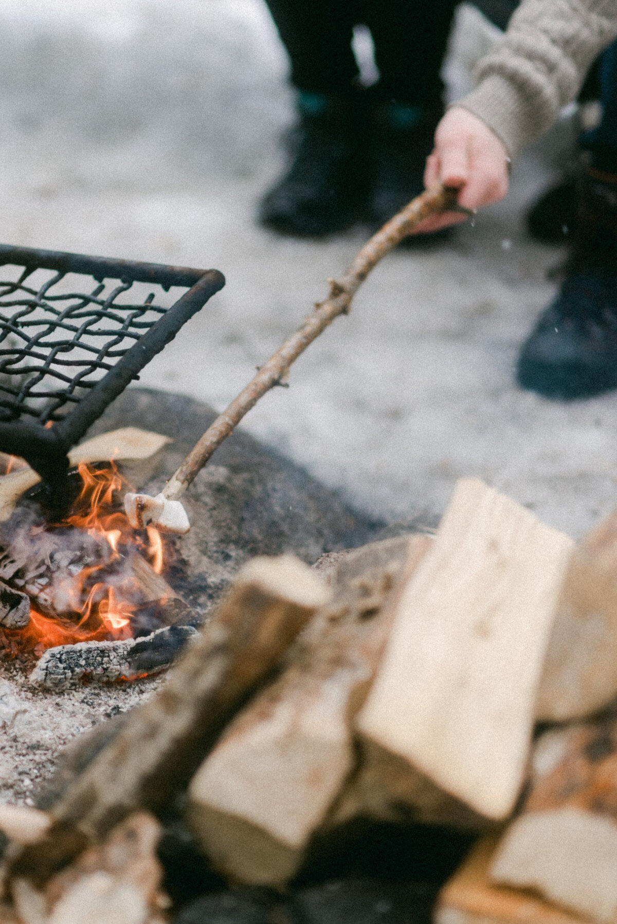 Couple by a campfire in a forest on a photography session with photographer Hannika Gabrielsson
