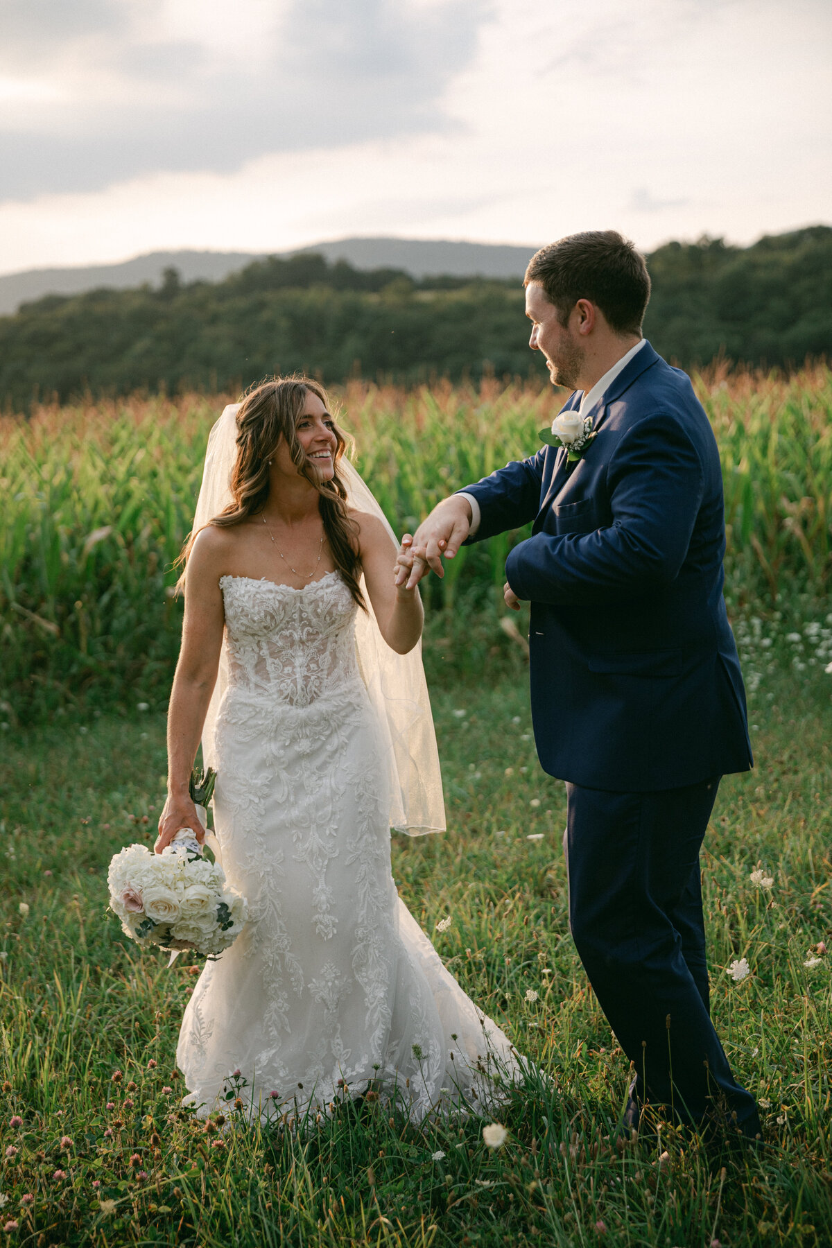 bride-groom-laughing-meadow-wedding