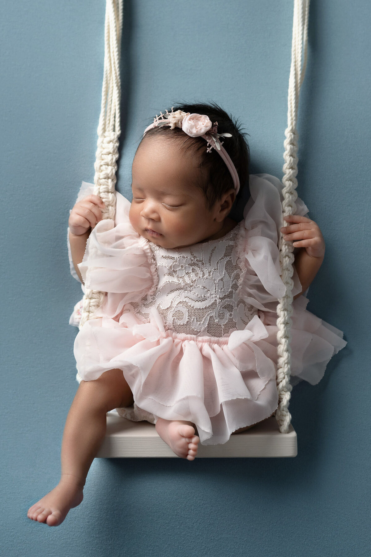 Newborn baby girl pink dress swing Cedar Park professional photographer 