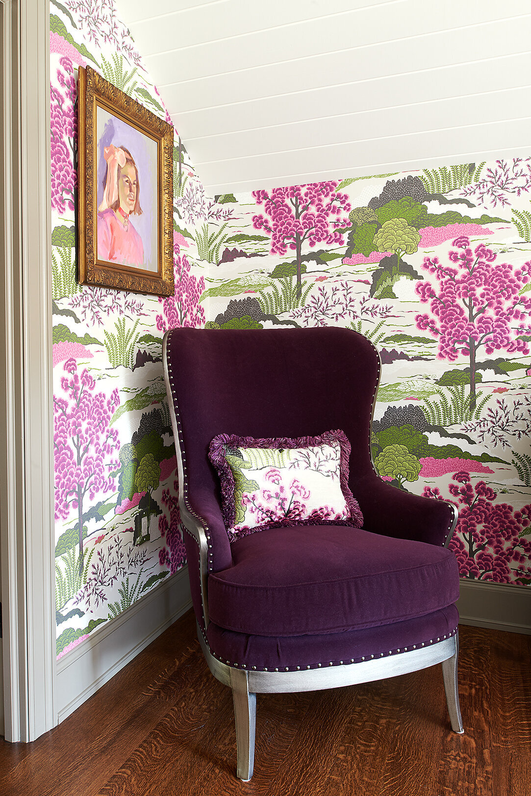 magenta couch with floral wallpaper