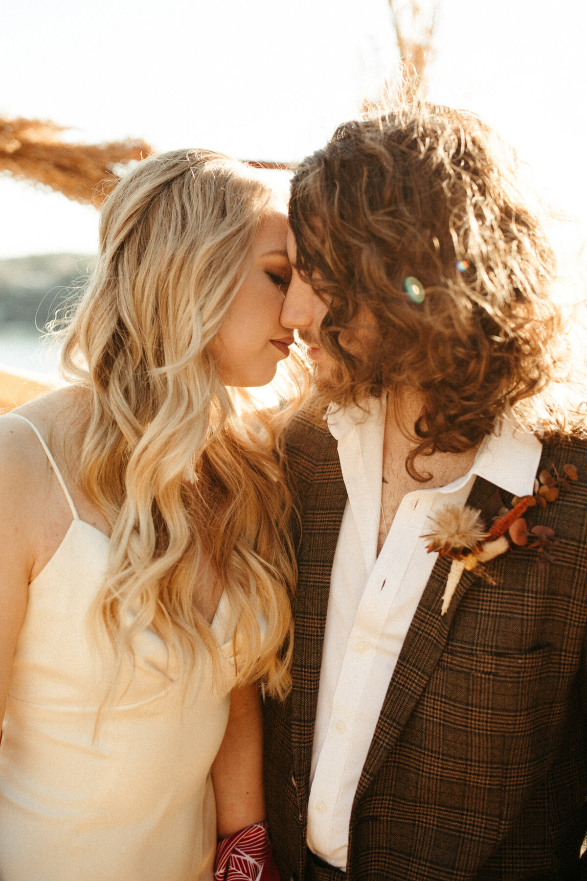 Boho bride and groom about to kiss during sunset elopement