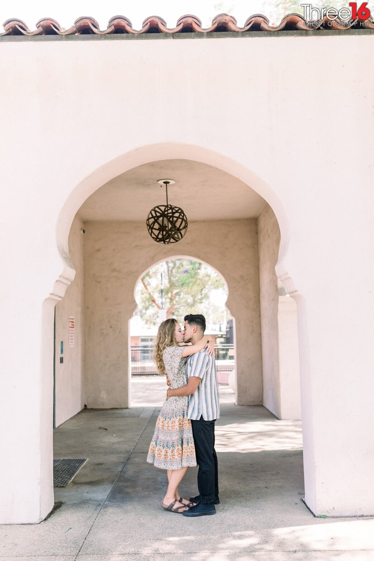 Future Bride and Groom share a romantic kiss under the archway at the Claremont Train Station