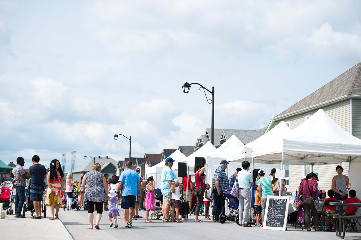 Ottawa event photography showing a wide angle view of participants walking and engaging with vendors during a corporate children's event.  Captured by JEMMAN Photography COMMERCIAL