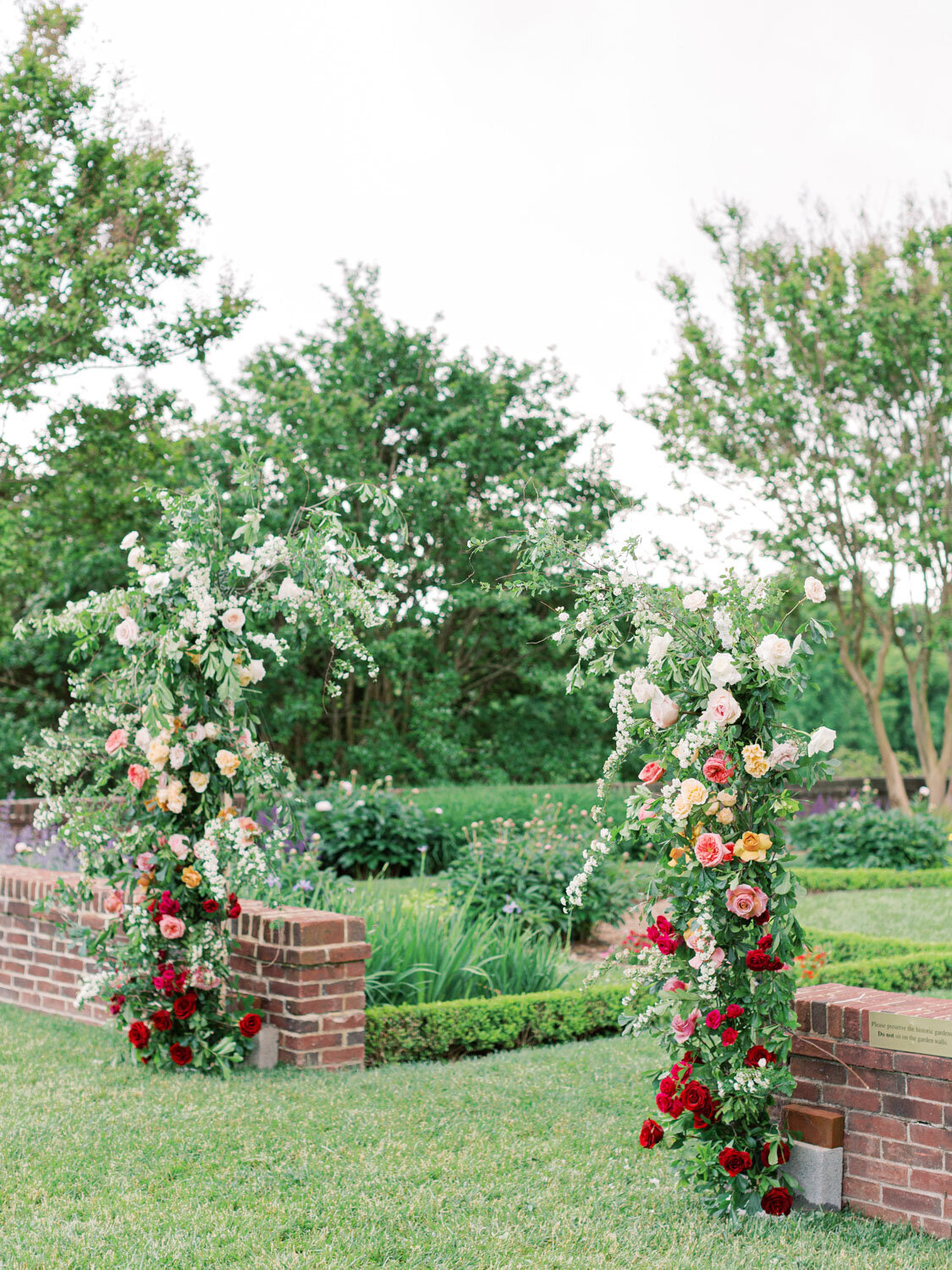 Outdoor ceremony arch decorated with flowers