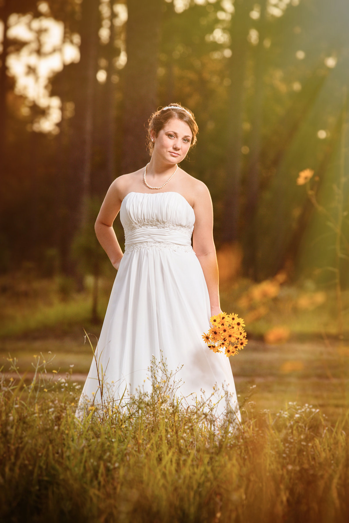 Bridal portrait in.a grassy field at Blakeley State Park in Spanish Fort, Alabama.