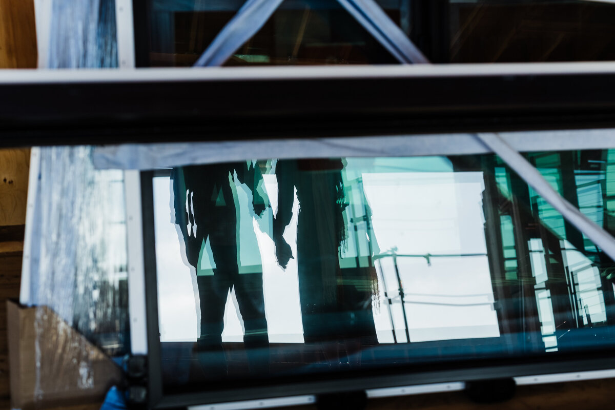 reflection-of-hand-holding-in-window