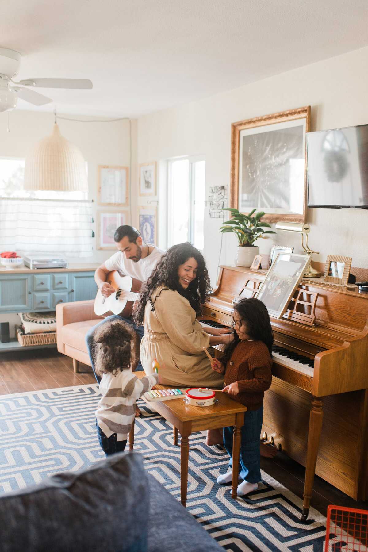 Family playing music and singing together in a living room