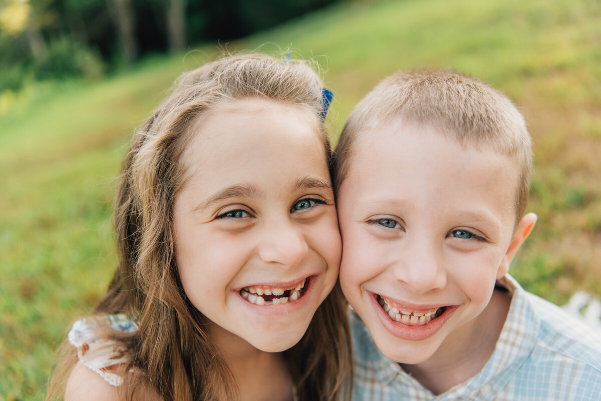 Close up of brother and sister in field