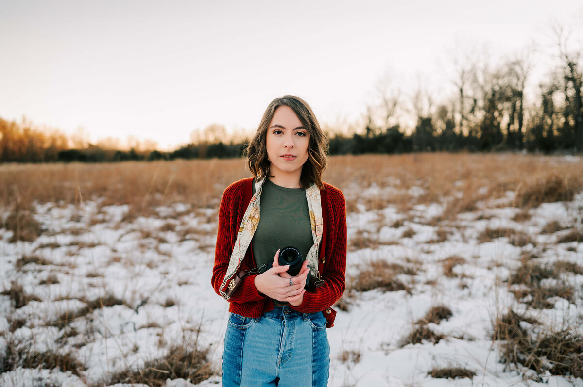 teen girl holding camera enjoying Branson senior photography
