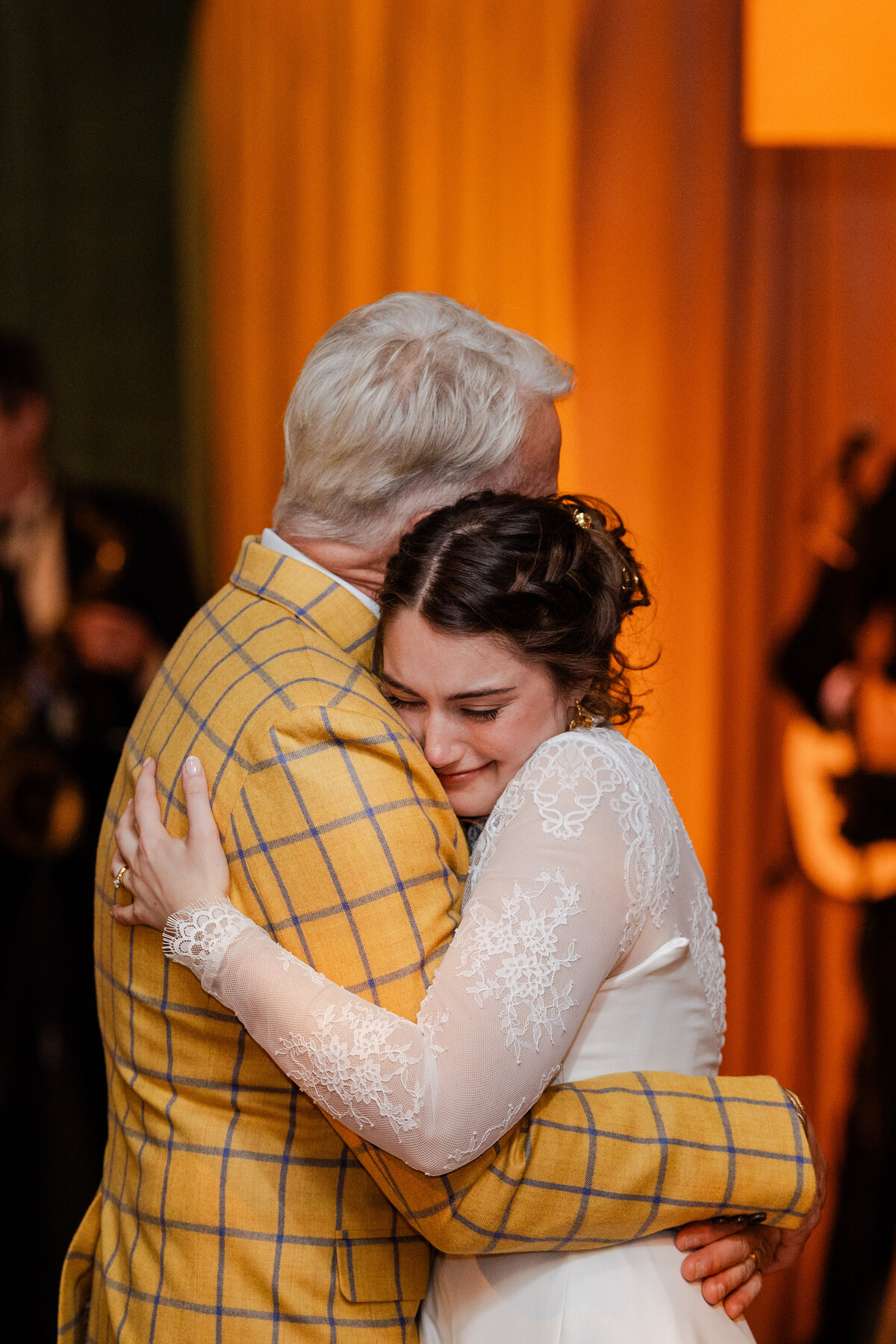 A Bride hugs her father at her wedding.