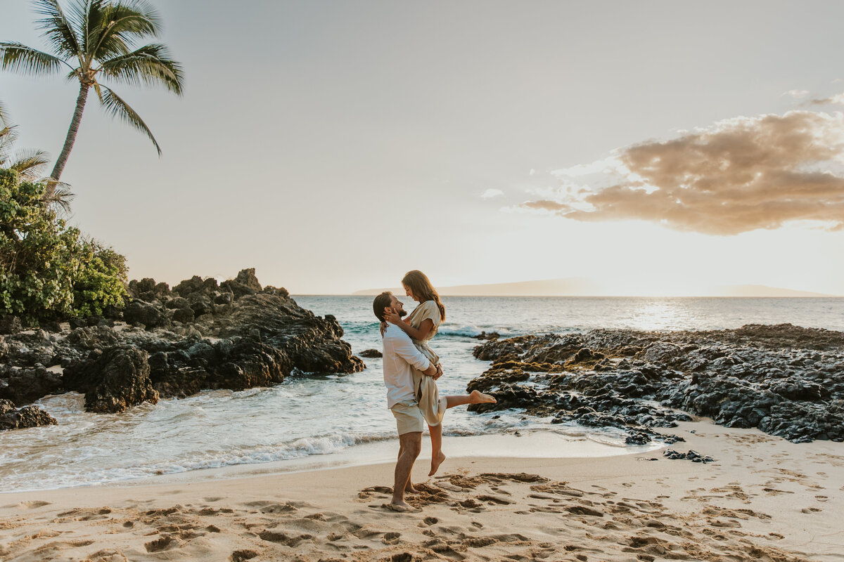 Hawaii Engagement Photographer captures man lifting woman