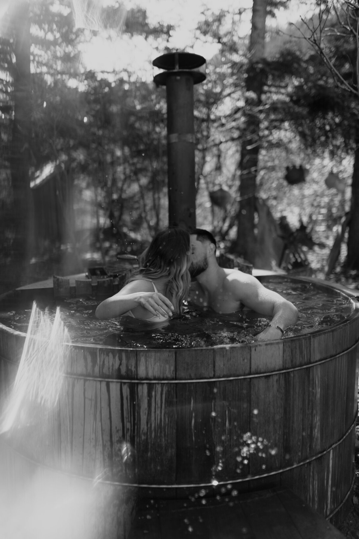 black and white image couple embracing in tub