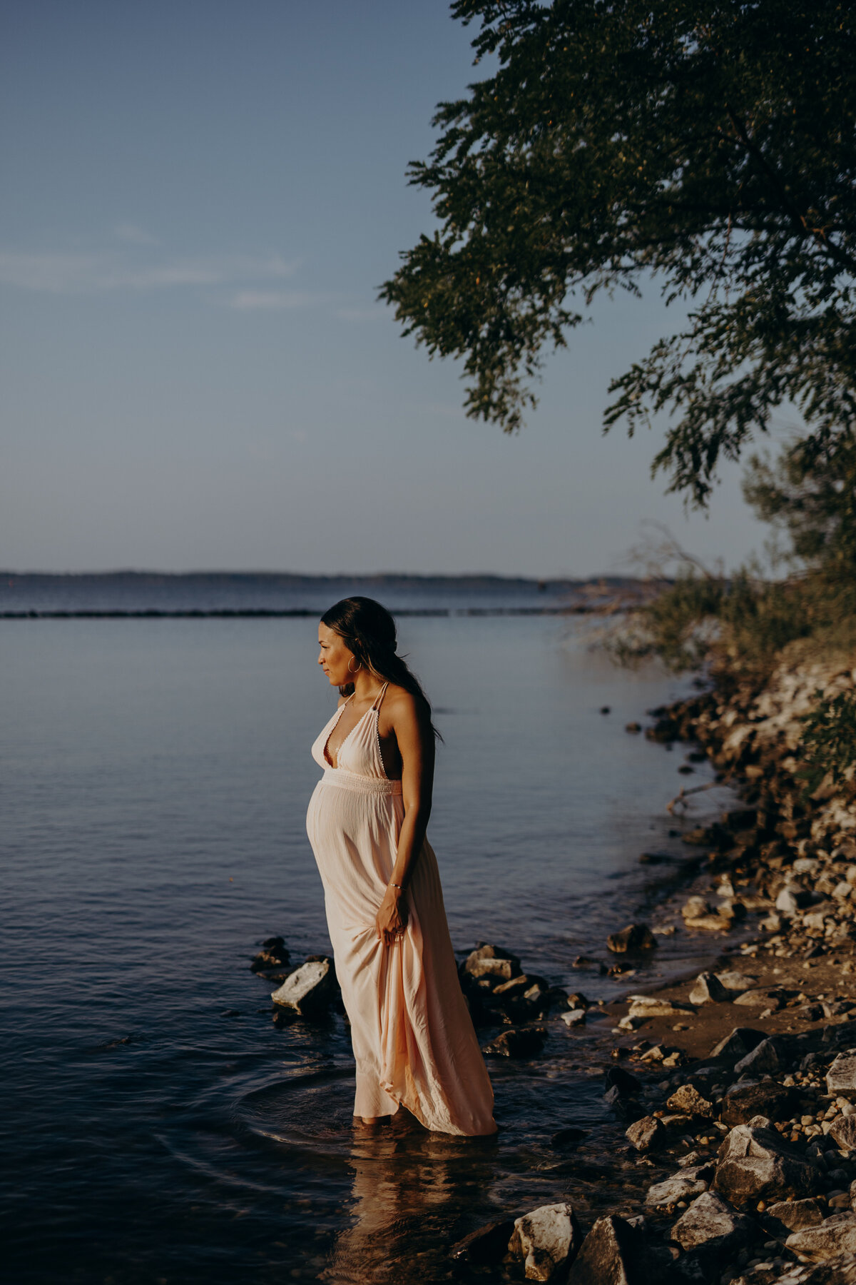 moody maternity photo on the water