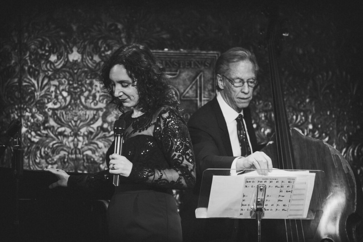 Two people standing on stage performing