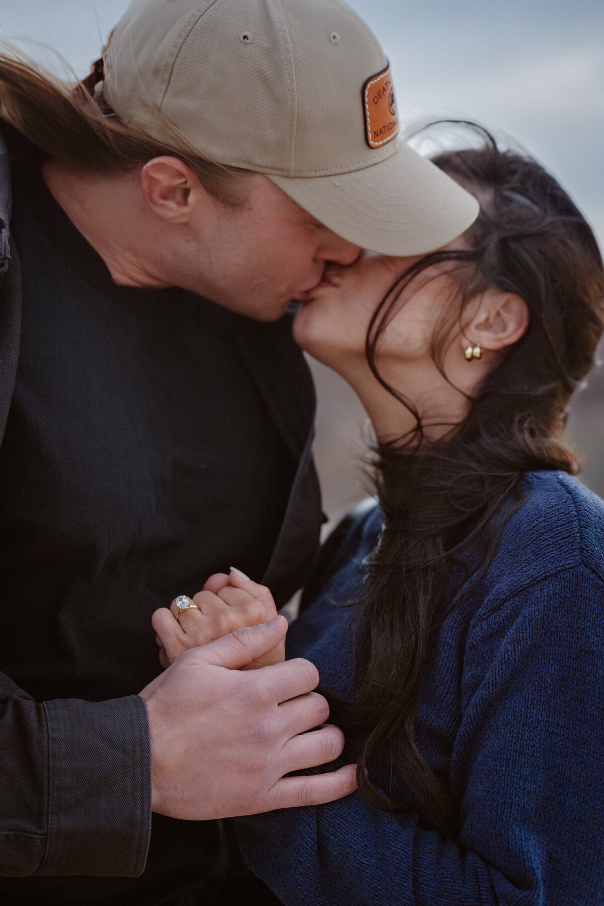 A couple kissing and holding hands
