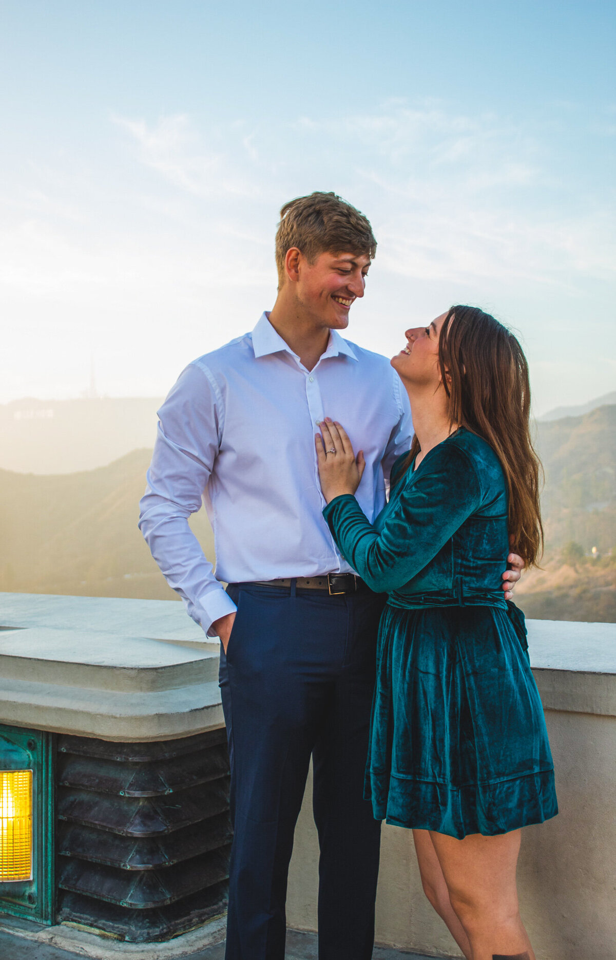 engaged couple embrace in griffith park
