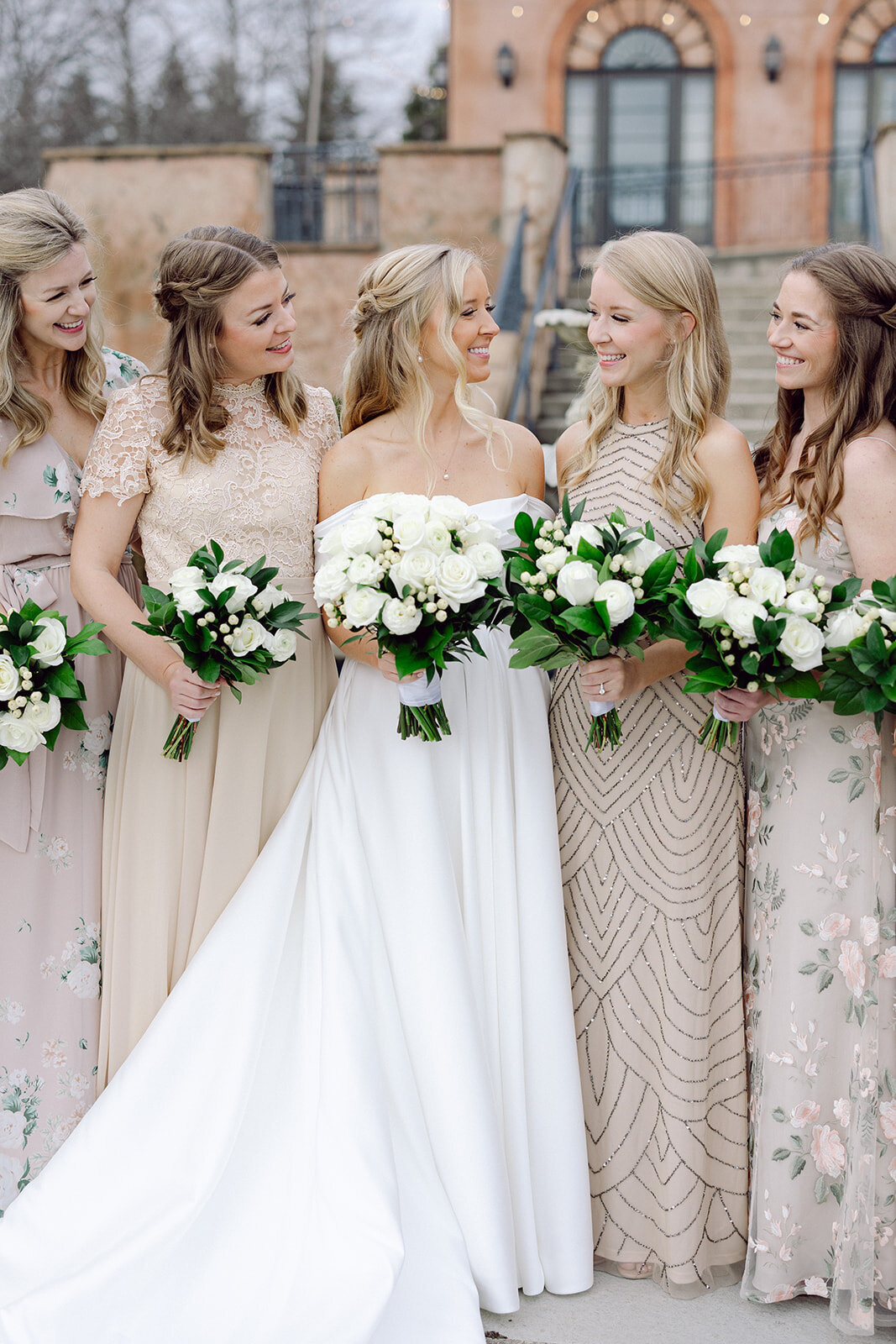 Bridesmaids smiling at each other  at a Columbus venue shot by Philadelphia photographer.