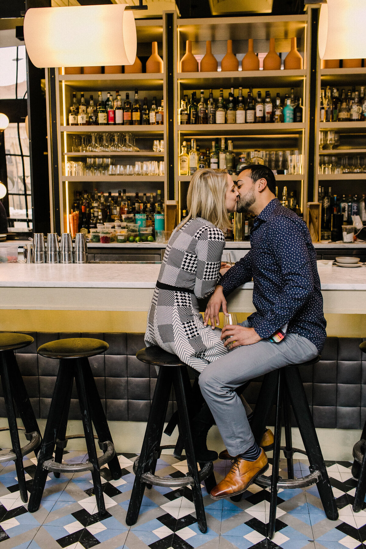 A couple poses for an engagement photo in their favorite West Loop bar in Chicago