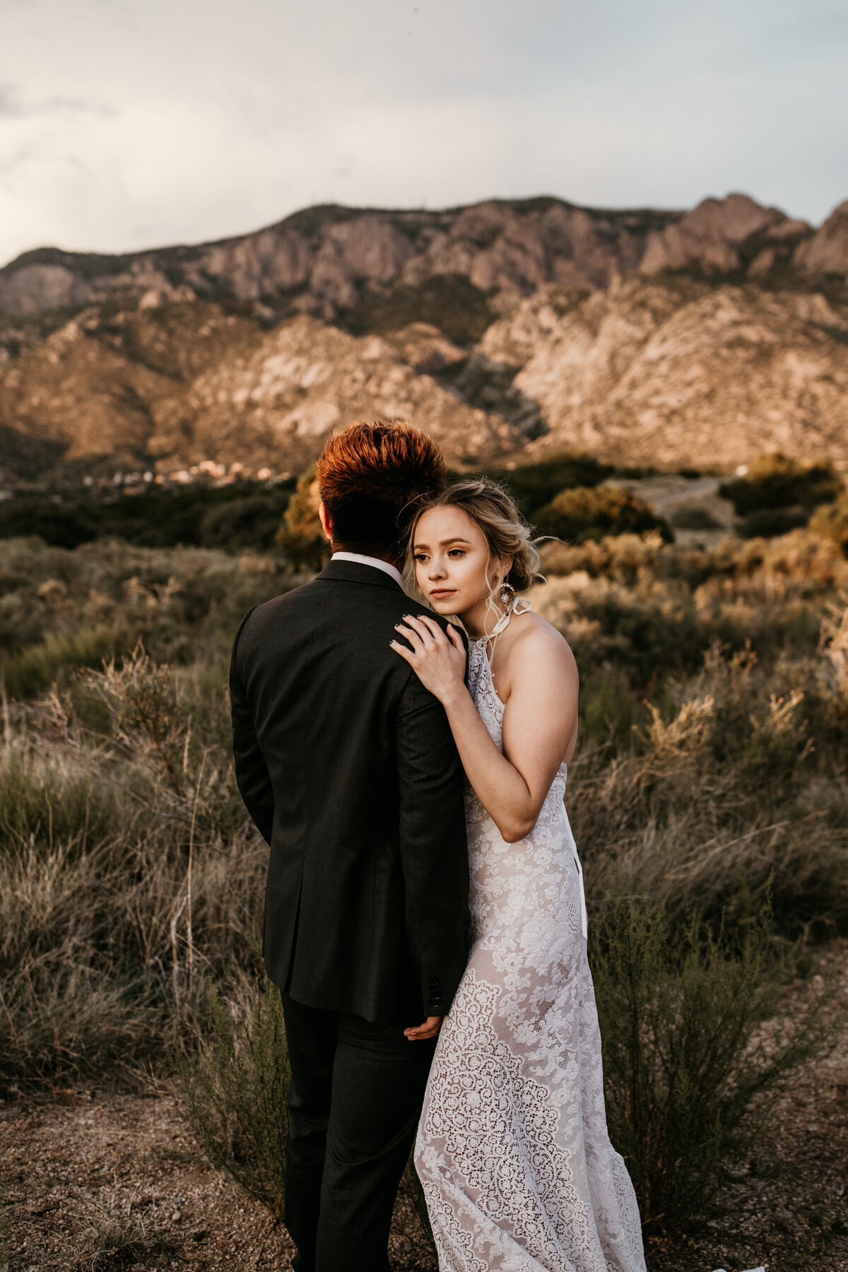 bride looking over grooms shoulder in Albuquerque