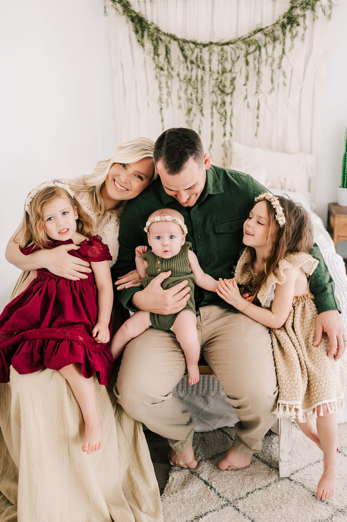 family cuddling on bench during Springfield Mo family photography session