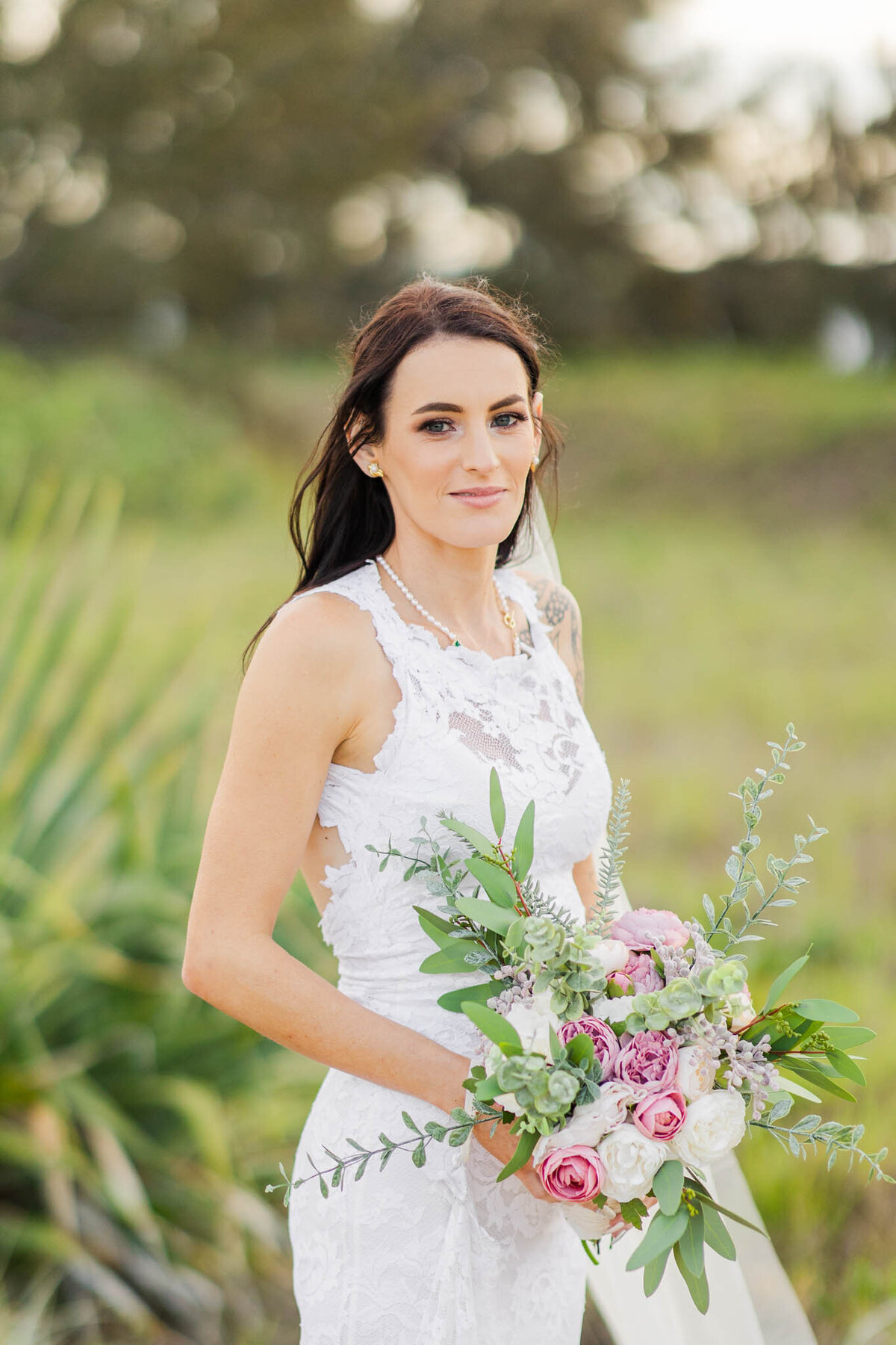 bride give a soft smile towards wedding photographer alyce holzy.