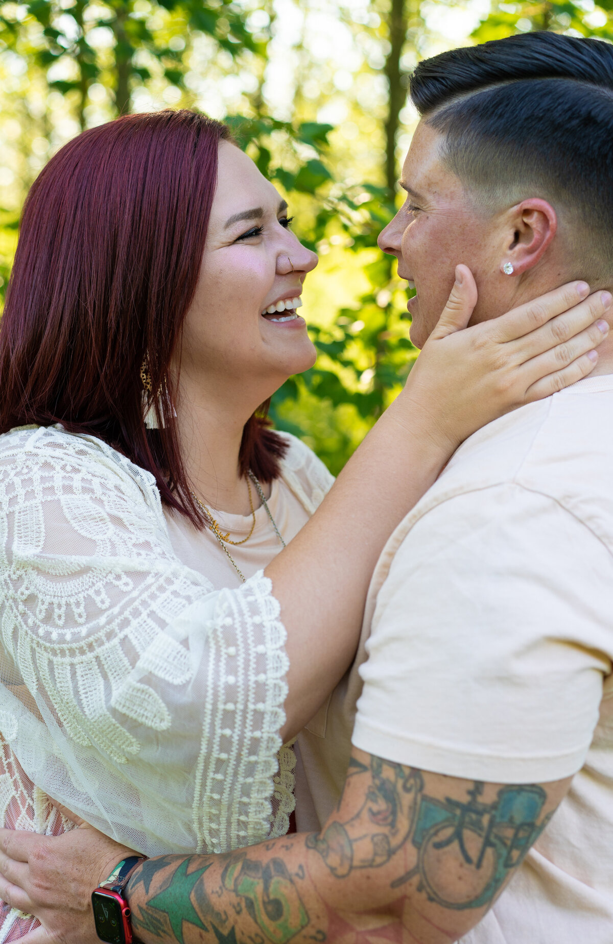 LGBTQ couple, Courtney and Jo, laugh as they romantically embrace at Walnut Woods in Groveport, Ohio.