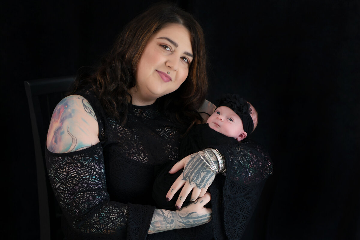 Alternative portrait mother and newborn baby girl in black