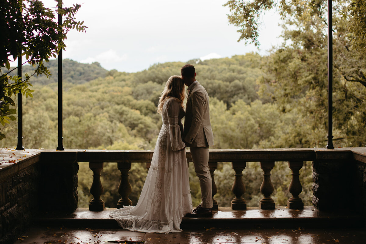 couple standing in wisteria arbor at cheekwood