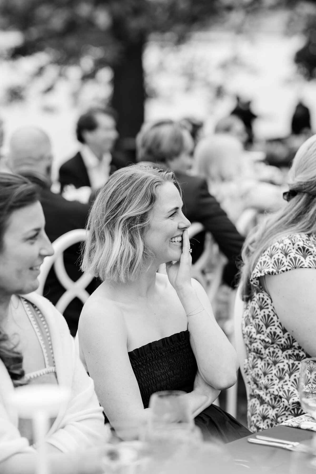 Guests laughing during rehearsal dinner speeches