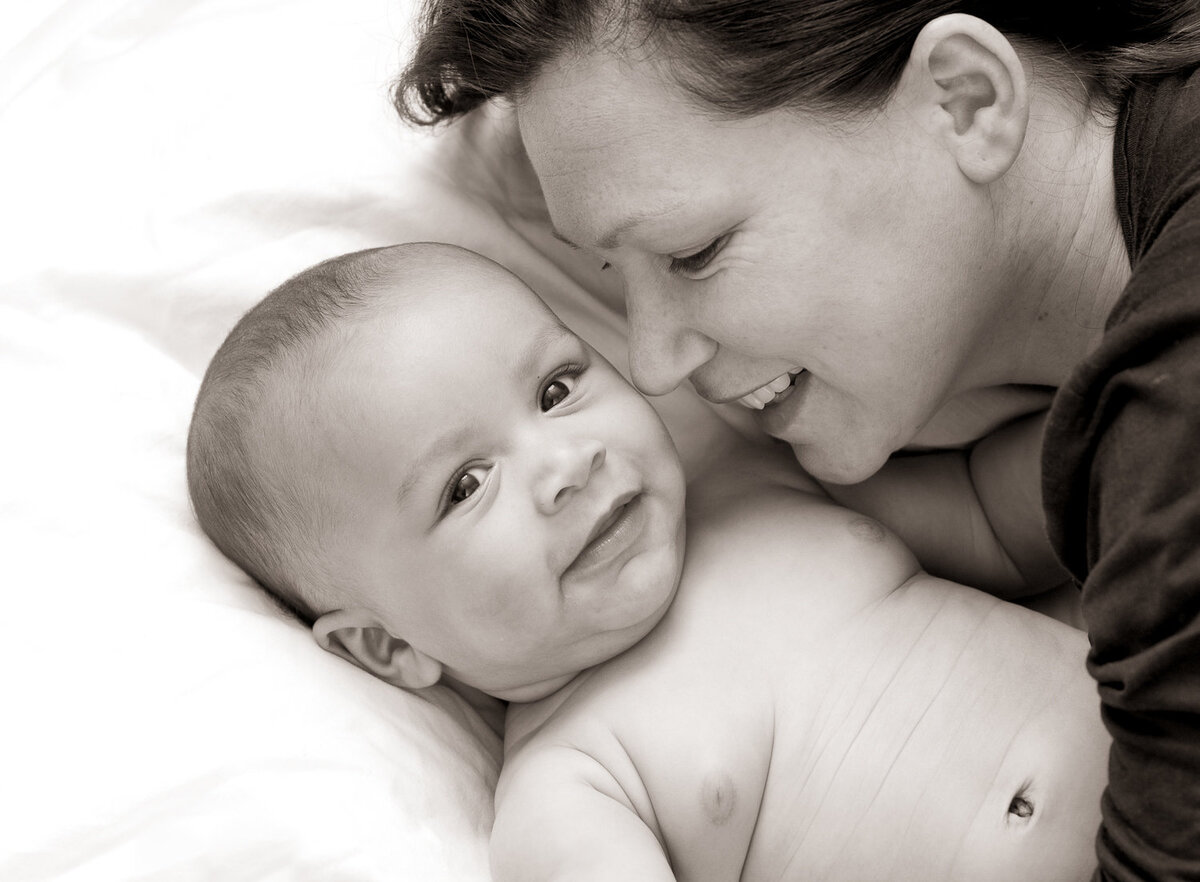black & white portrait of a mother and baby smiling