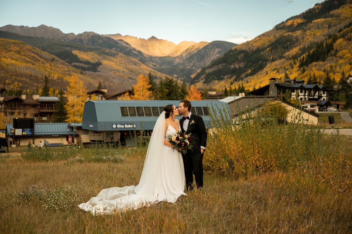 Bride and groom kissing in Vail, Colorado.