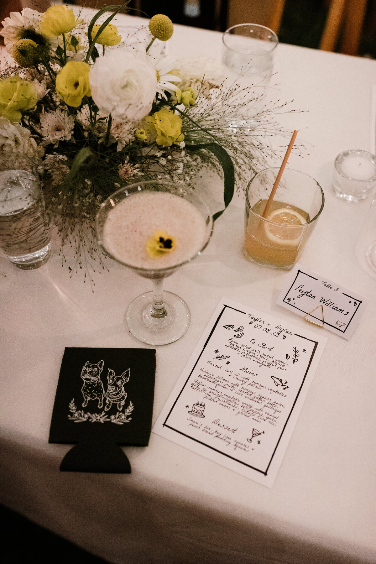 Table with martini, cocktail, menu and florals