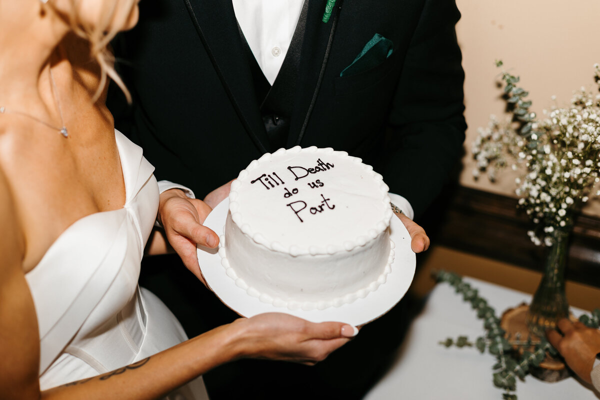 Bride and Groom holding wedding cake