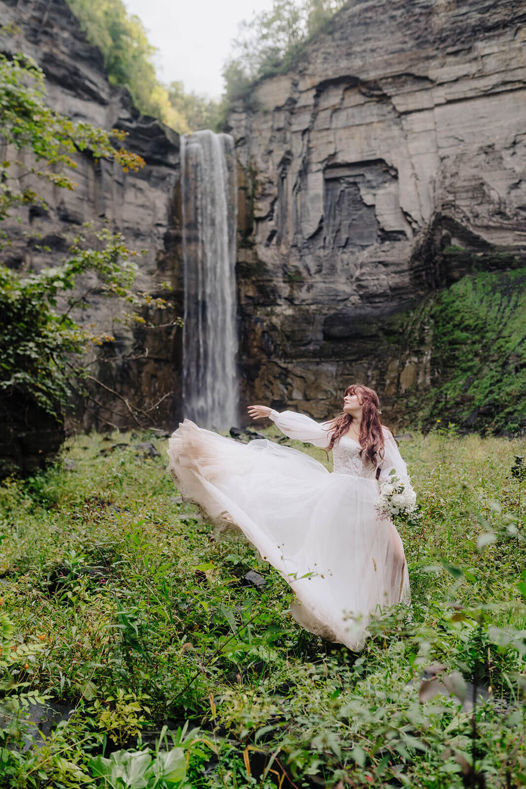 bride with flowing dress in front of waterfall at Finger Lakes wedding, NY