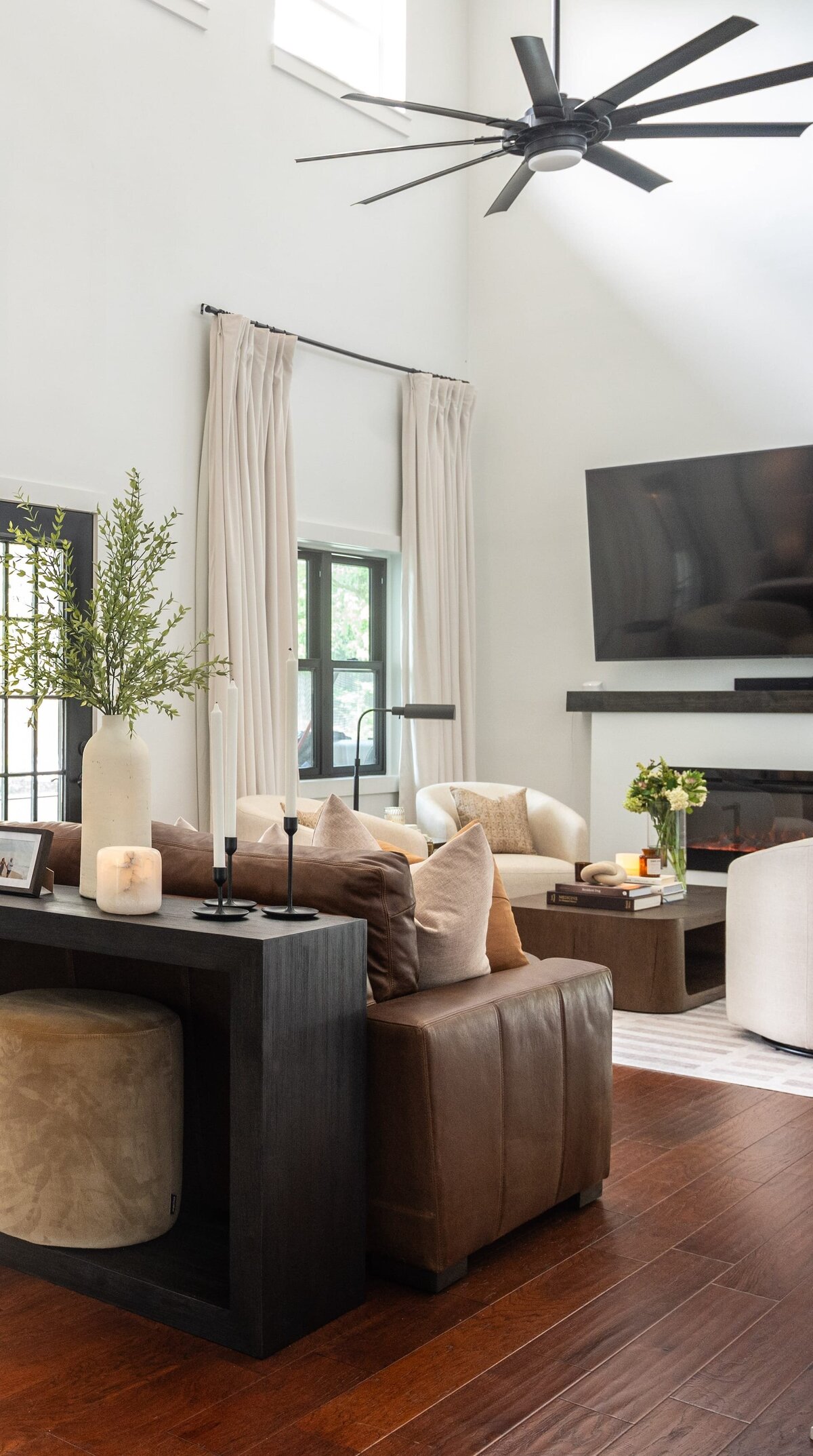 dewine design orlando interior design farmhouse modern living room with vaulted ceilings and large black fan