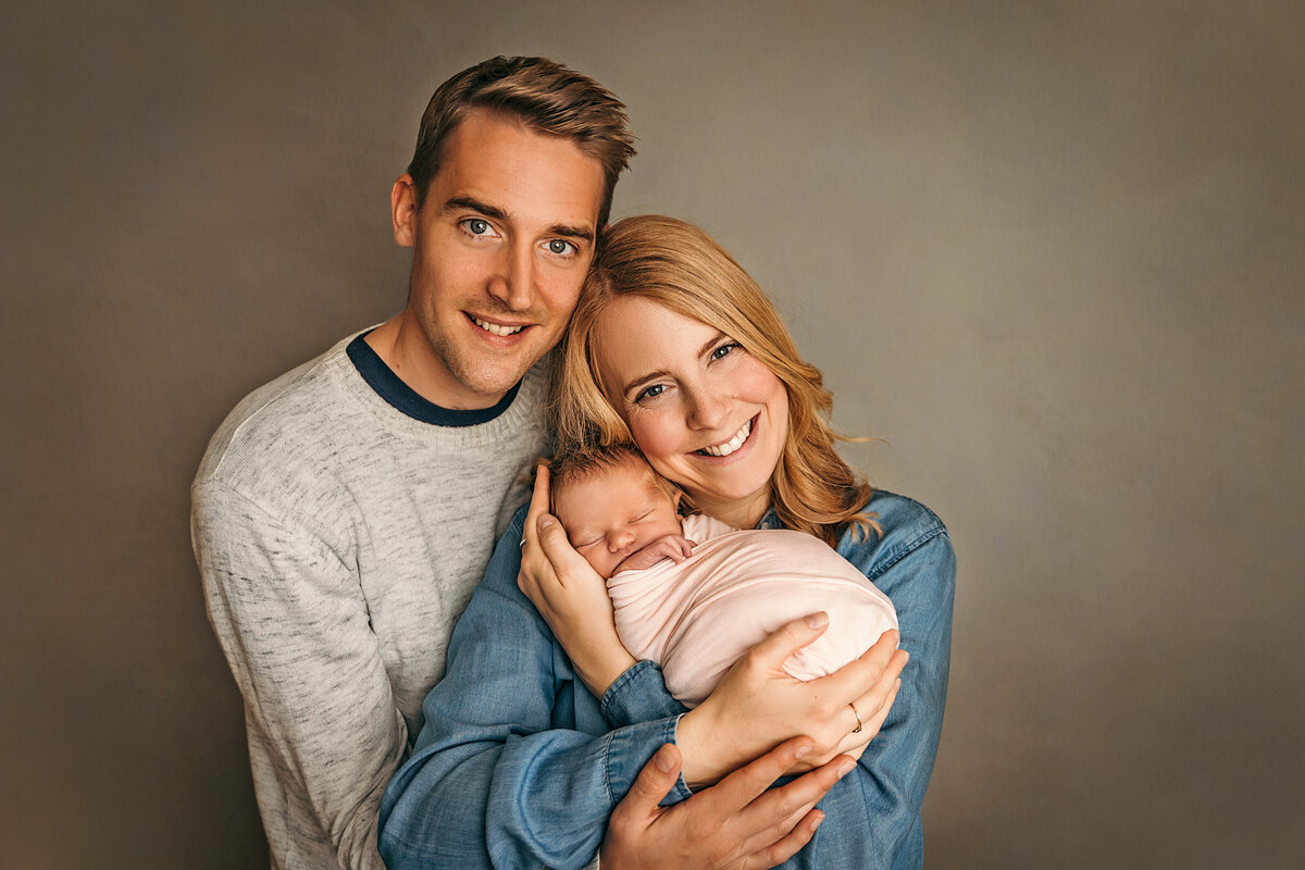Parents with newborn baby in portrait