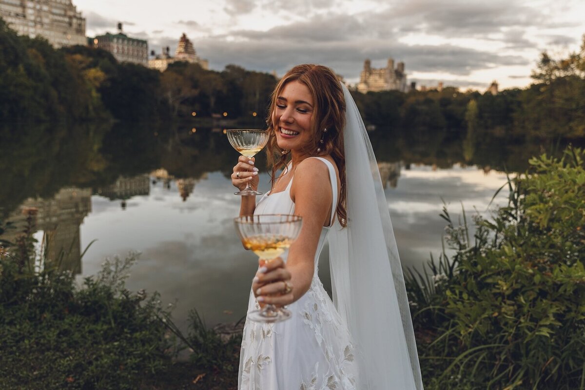 Bride laughing with glass of champagne in hand