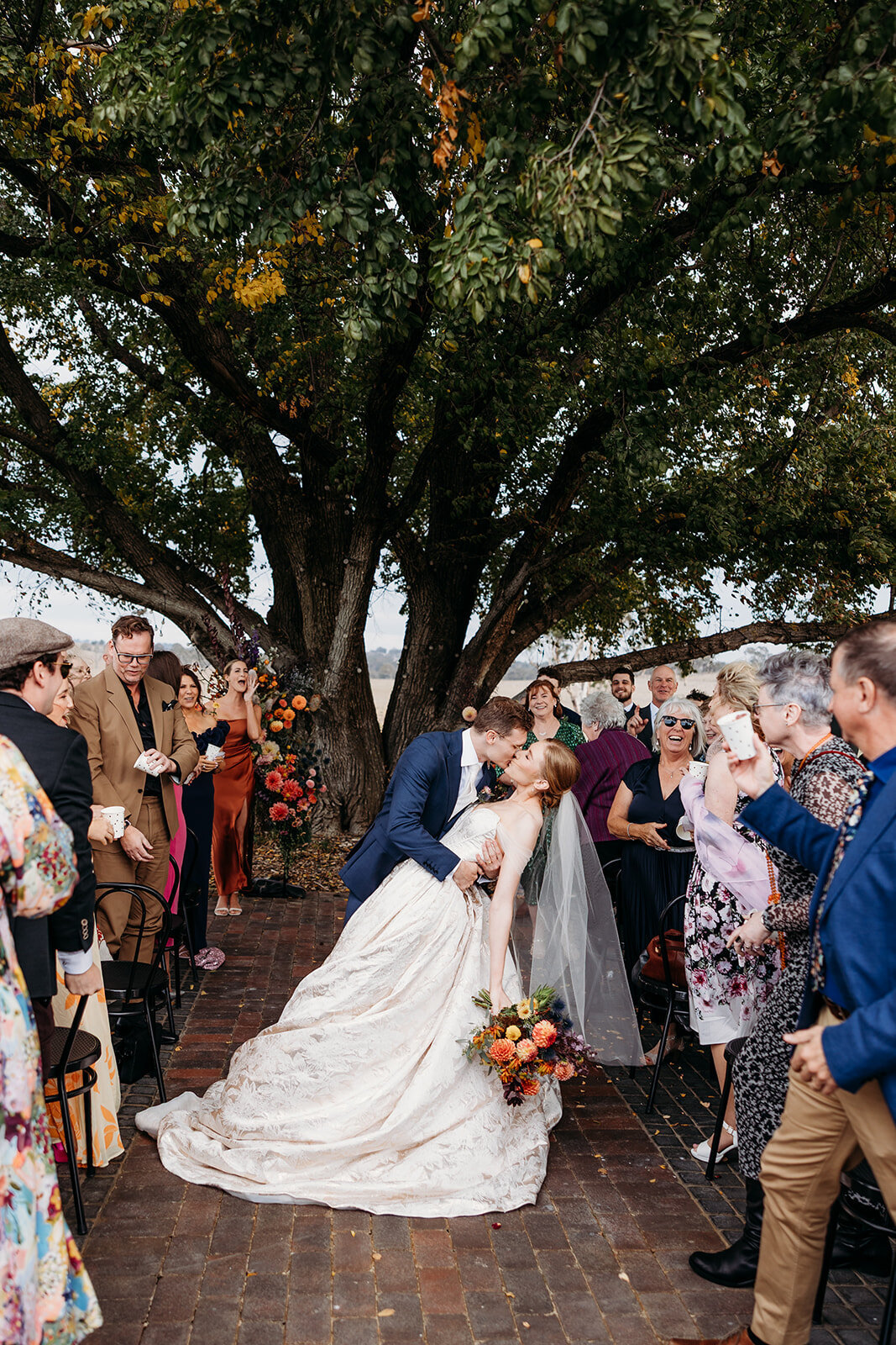 Bride and groom 'dip kiss' after their wedding ceremony at Petrichor Farm