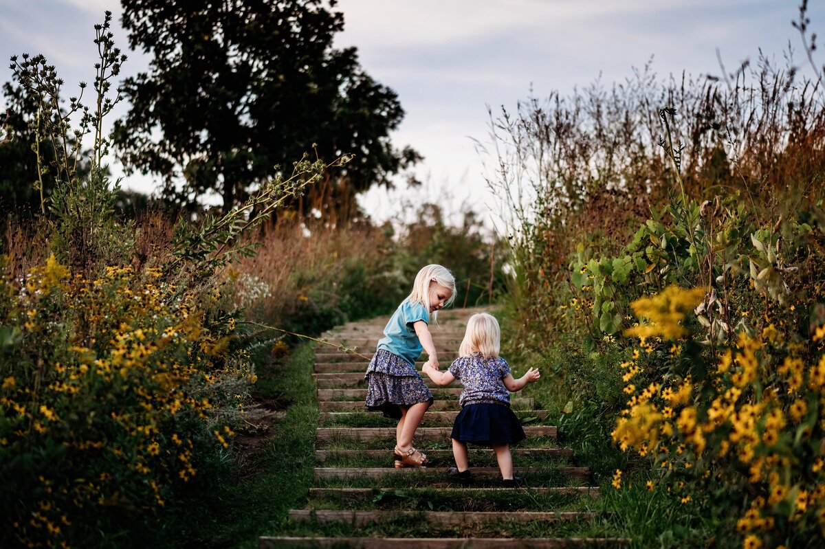 Sisters on staircase McKennaPattersonPhotography