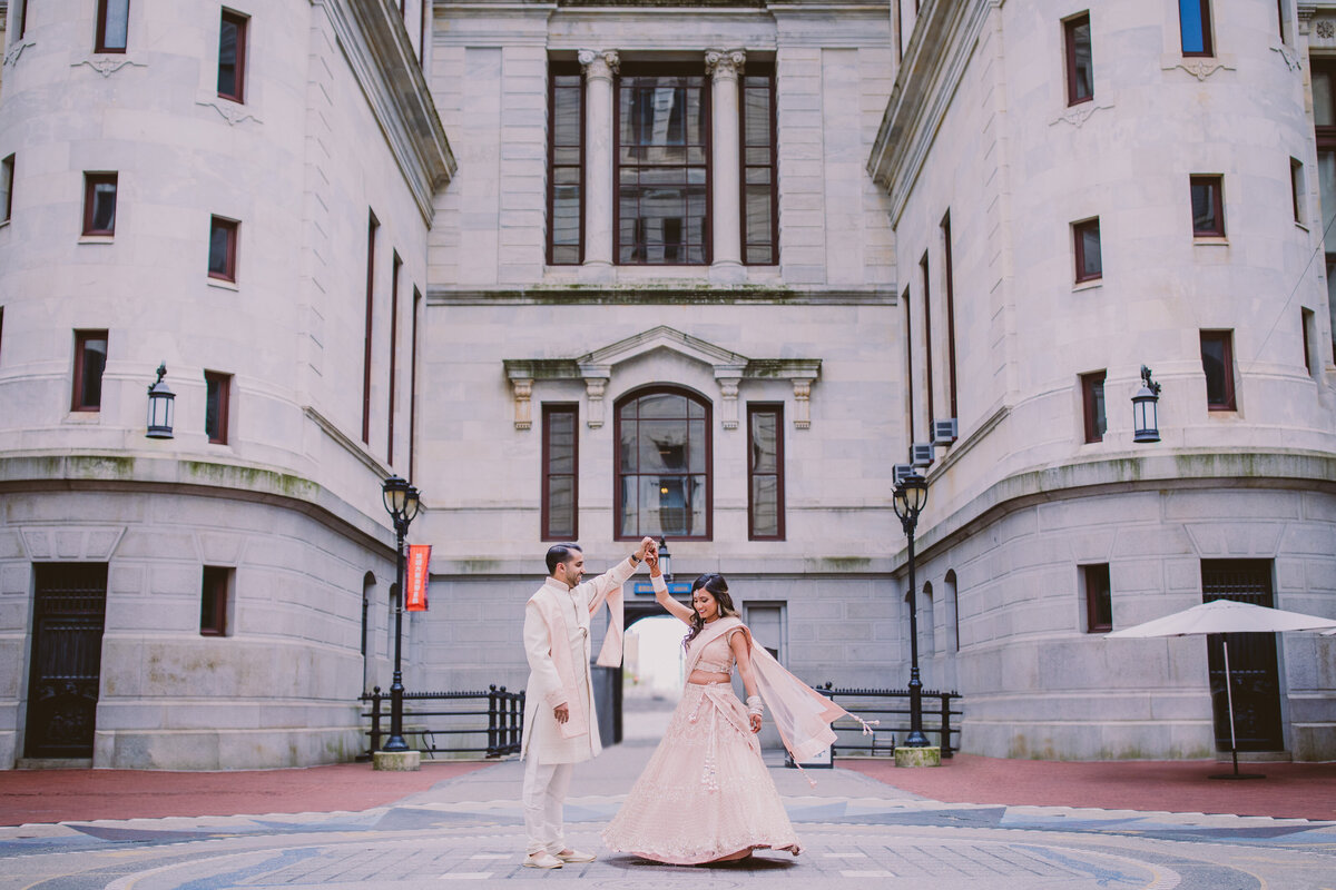 groom twirling bride during indian wedding at the philadelphia city hall 