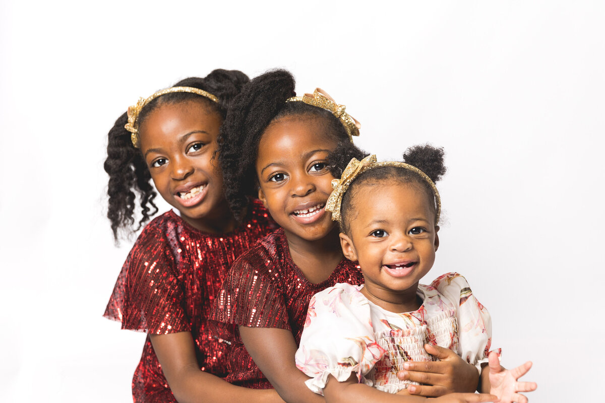 Happy siblings during family photoshoot at home on the pop-up studio.