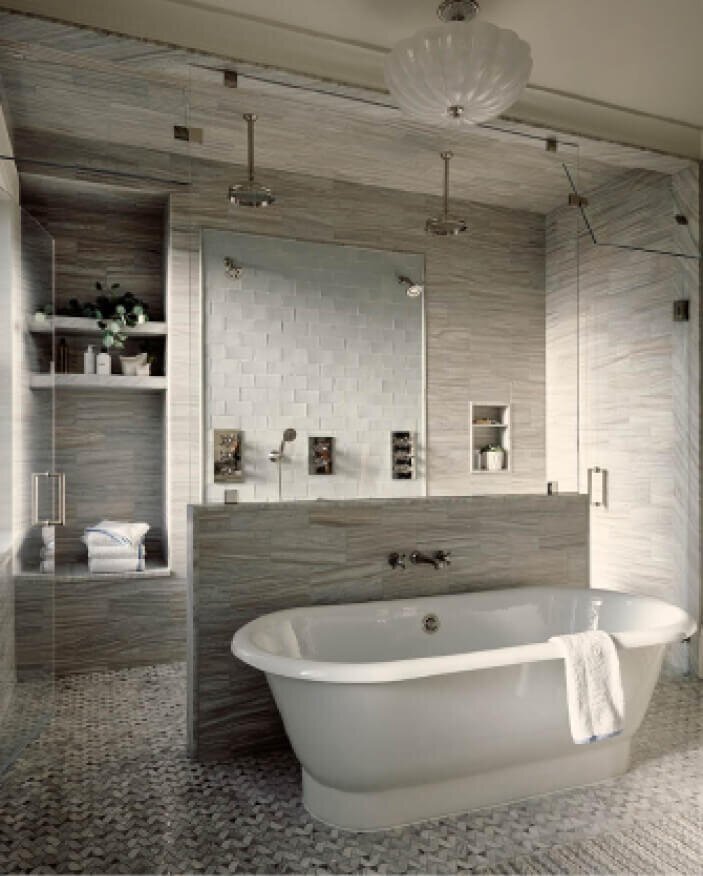 Brownstone Interior Designer designed a primary bathroom with a freestanding tub and stone and ceramic tile from Waterworks in a South End renovation project.