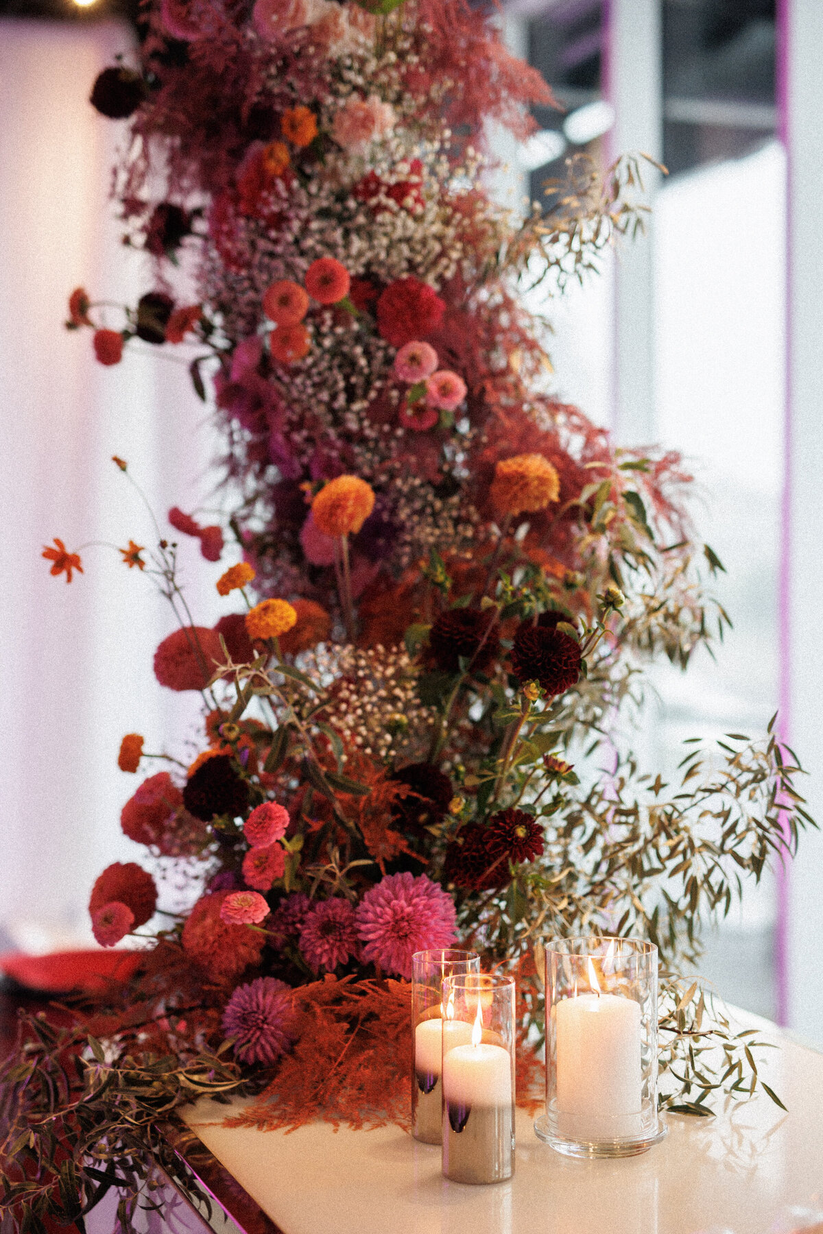 A colourful, modern flower arrangement at a wedding reception bar at the Science Centre. 
