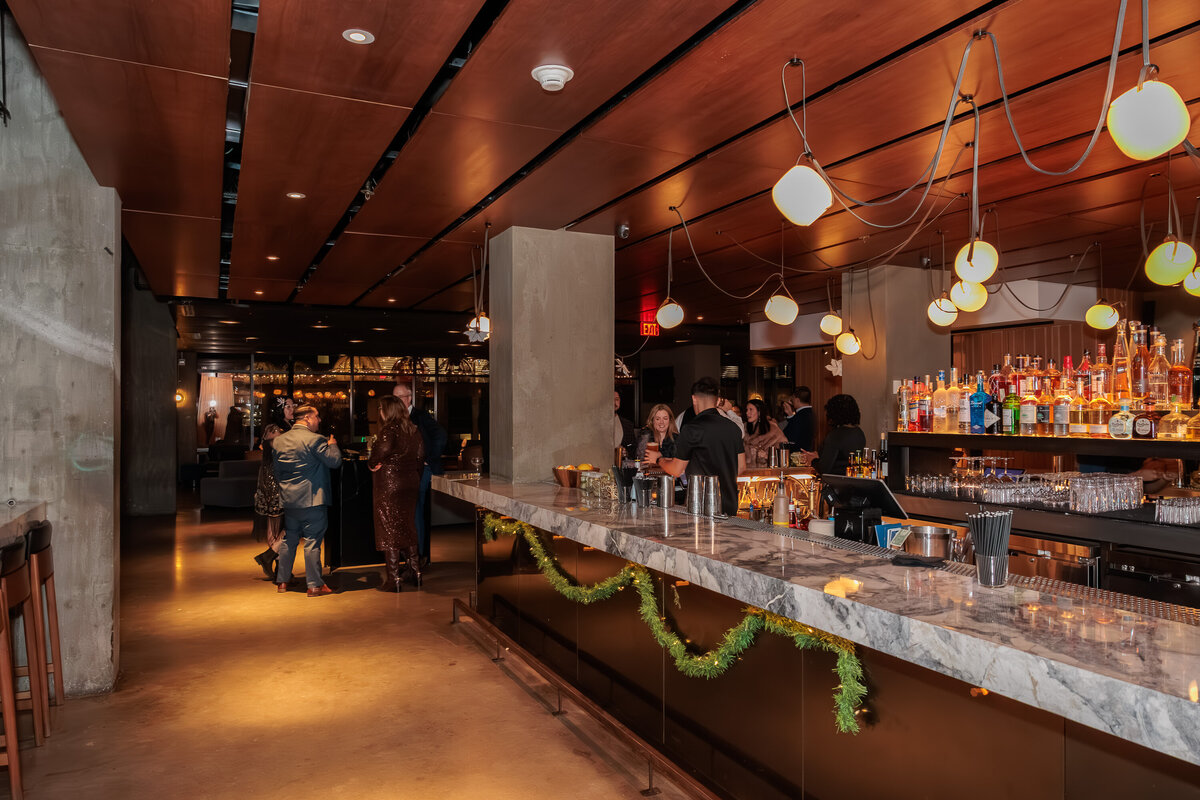 Wide angle shot of a bar in DC during a corporate business holiday party 