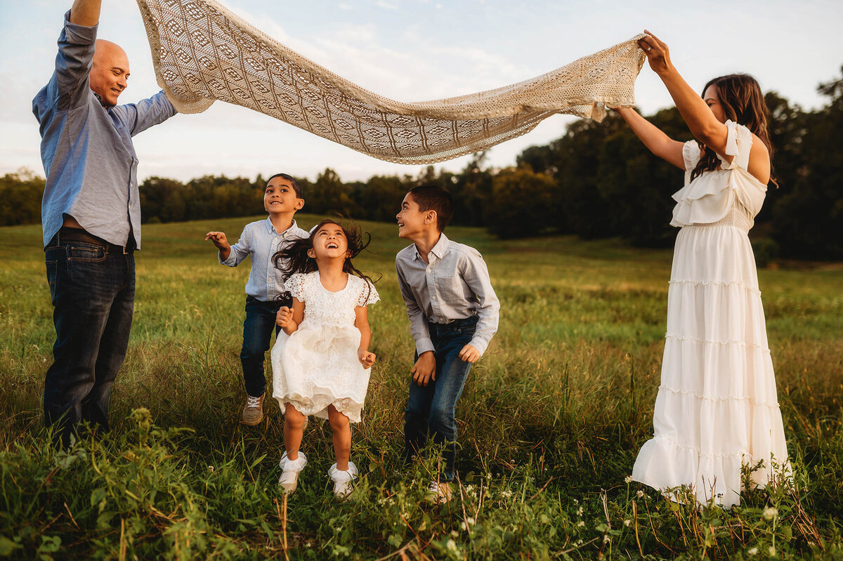 Family plays together during Family Photos at Biltmore Estate in Asheville, NC.