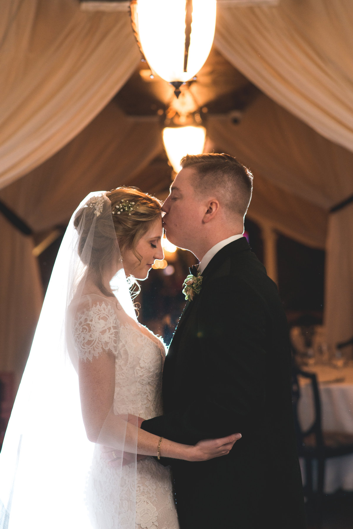 photo of groom kissing bride on the forehead from wedding at The Carltun