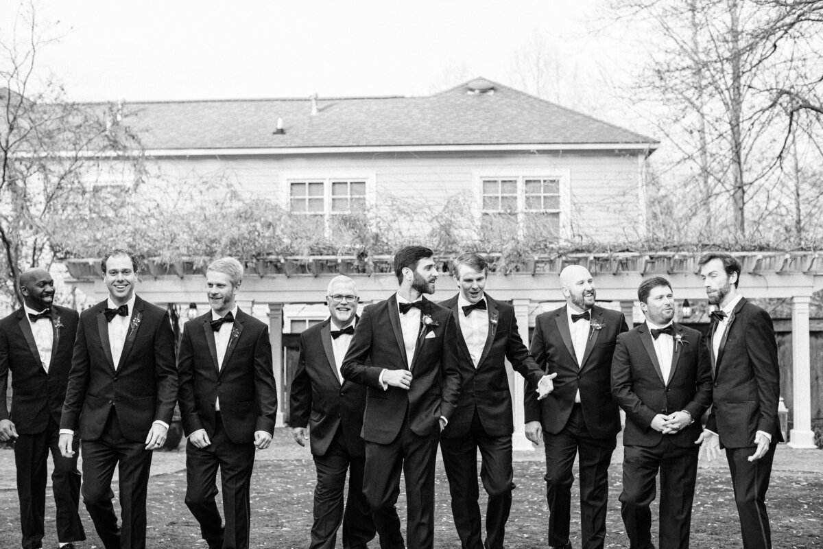 Groomsmen walking in the lawn at Isom Place