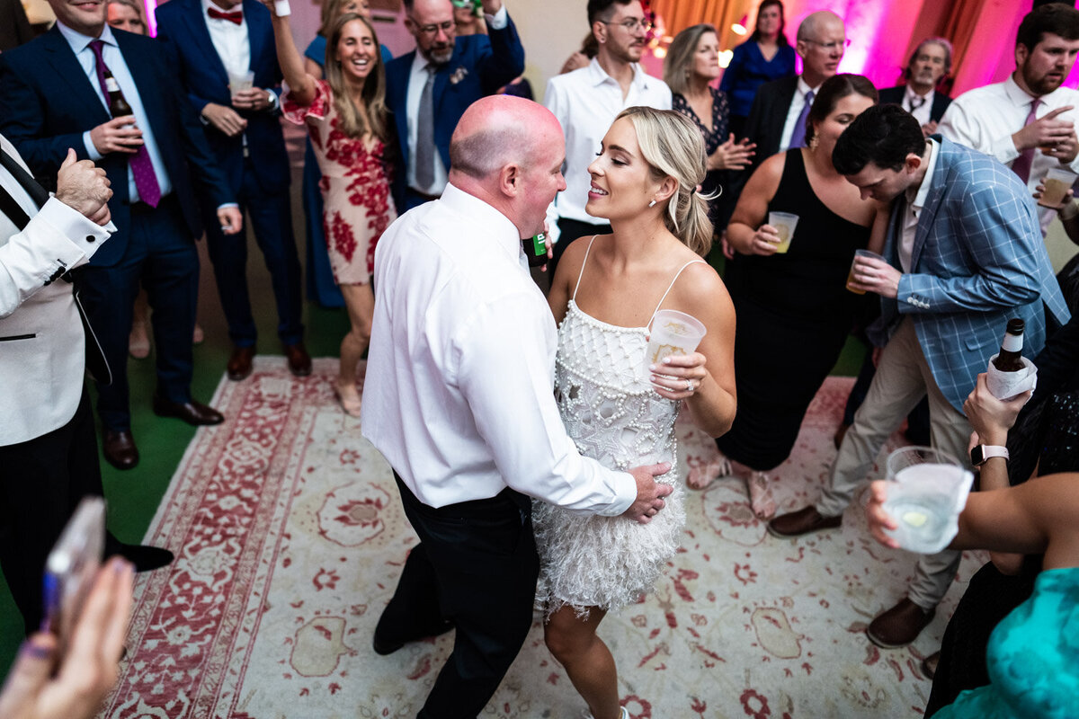 Bride and groom dancing at Latrobe's with guests in the background
