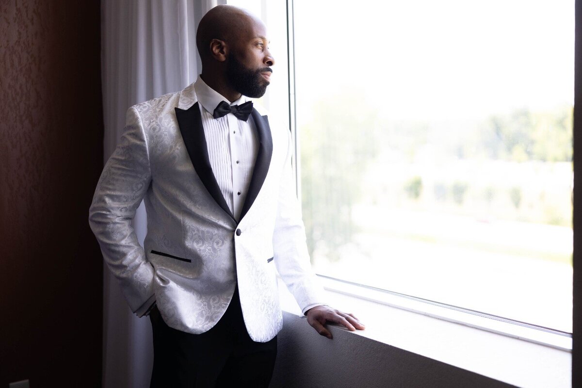 groom-looking-out-window-renaissance-hotel-carmel