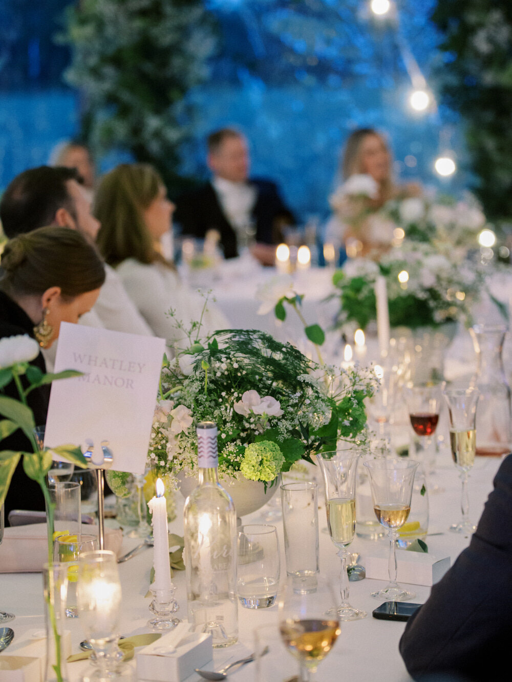 candle lit wedding table , guests sitting and listening wedding speeches